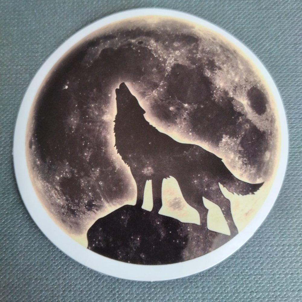 Wolf howling at full moon sticker